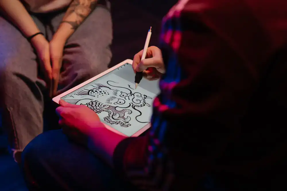 Artist sketching concept art on a digital display